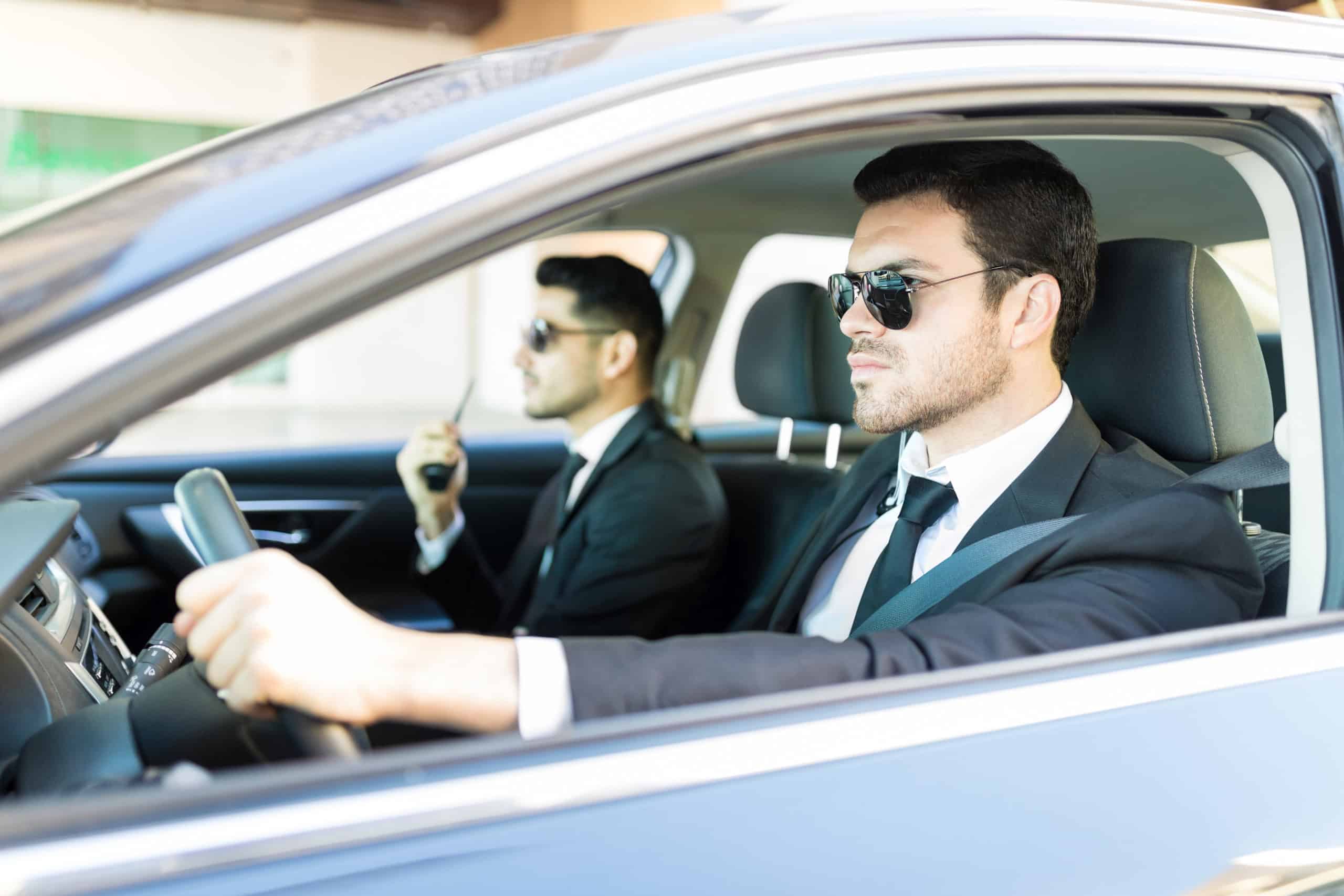 Bodyguards in luxury car acting as security chauffeurs in Dubai